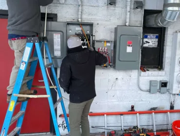 Electricians working on electrical and power box